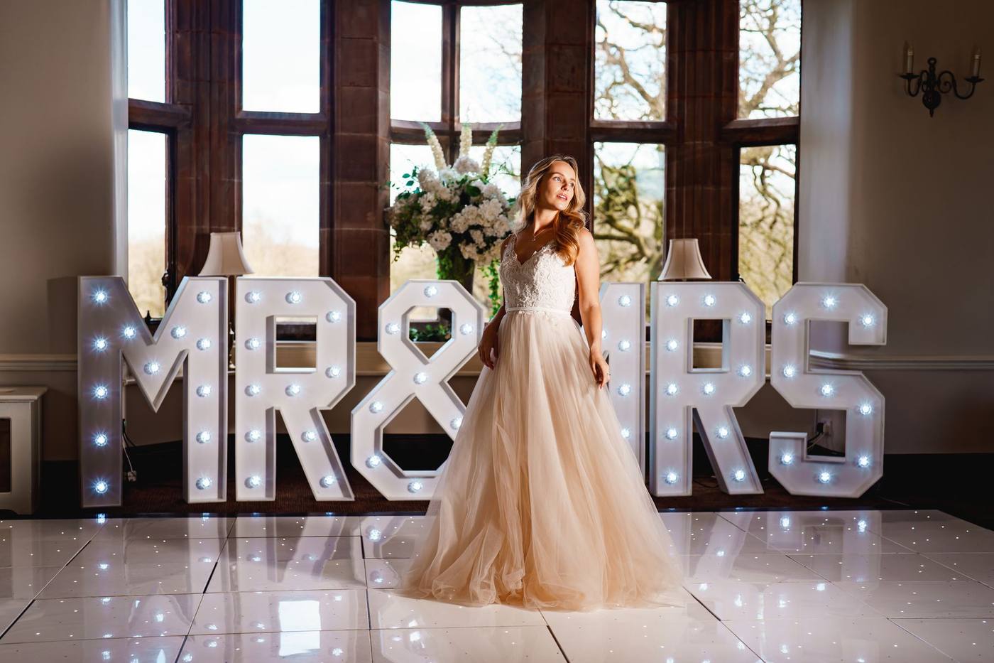 Bride on the dance floor with the Mr and Mrs letters