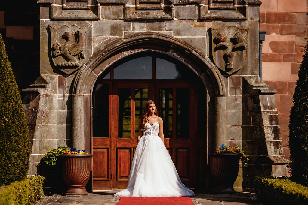 A bride at the carved stone entrance of the Abbey
