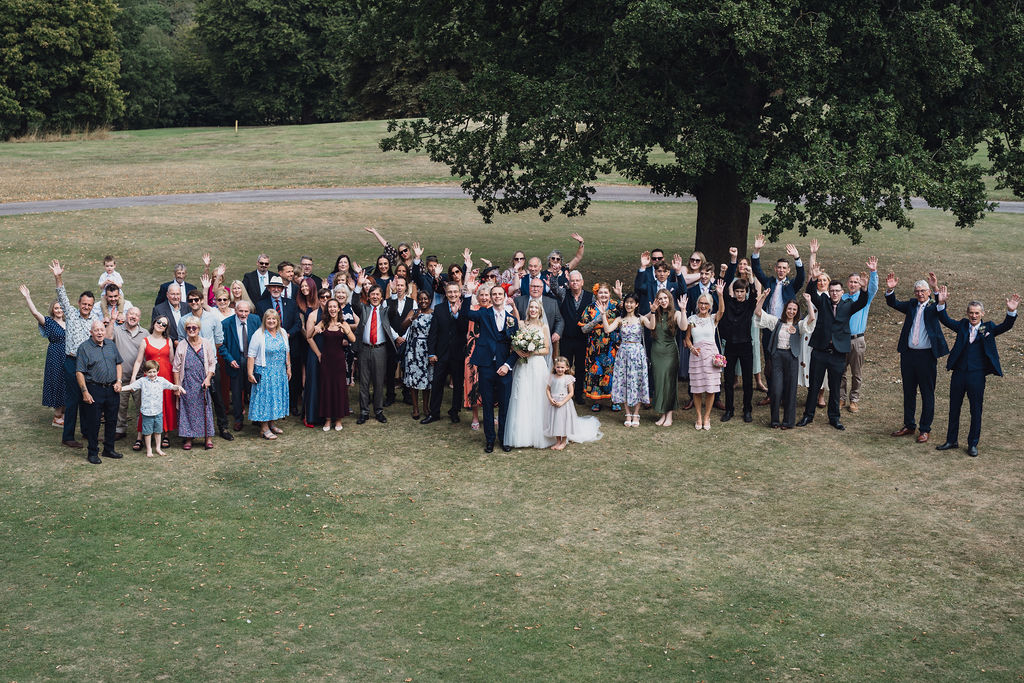 A wedding party on the lawn under the oak